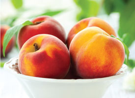 bowl peaches leaves
