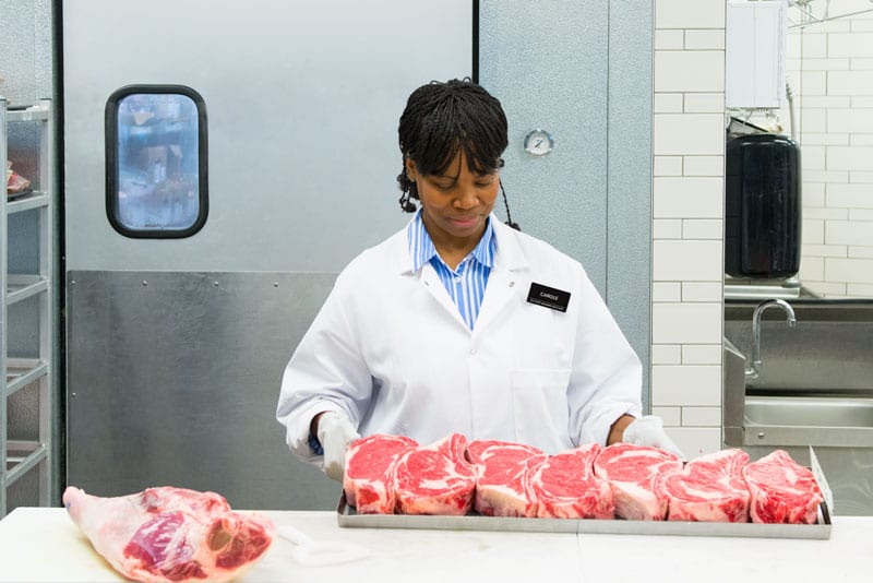 butcher with steaks