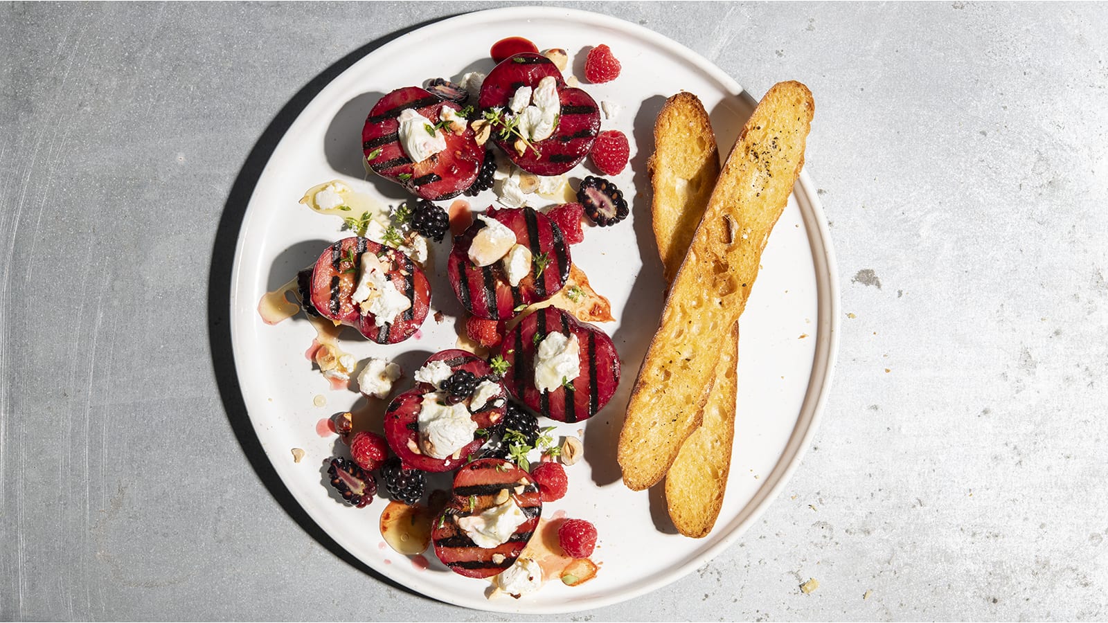 Grilled Pluots with Bianca Cheese and Toasted Hazelnuts
