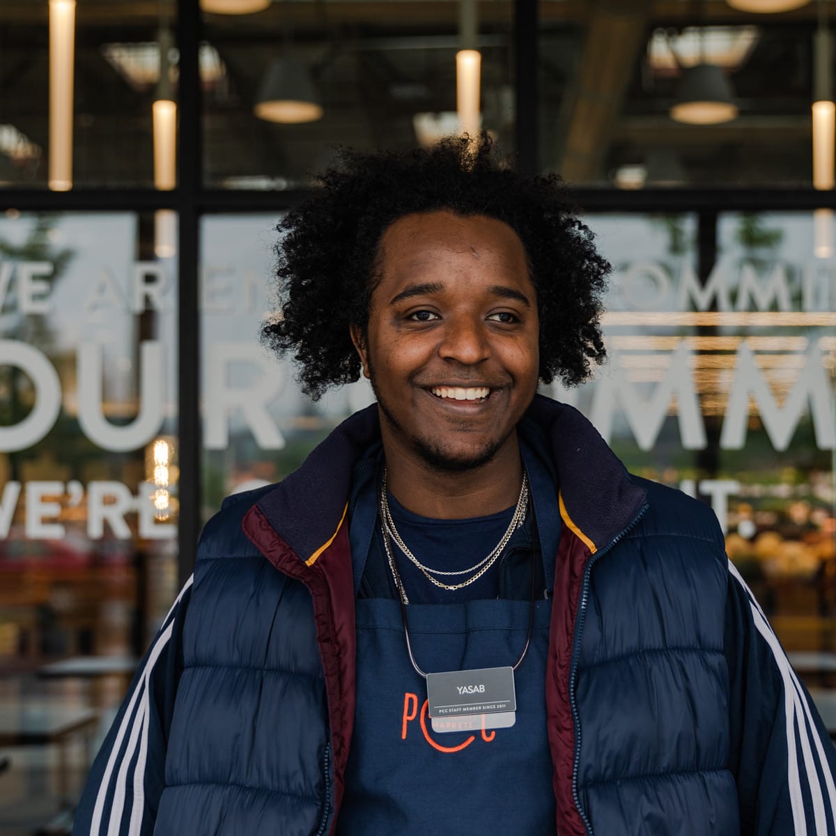 Yasab standing outside store