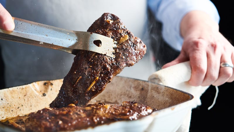 Grilled Garlic-studded New York Steaks