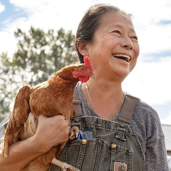 woman holding chicken