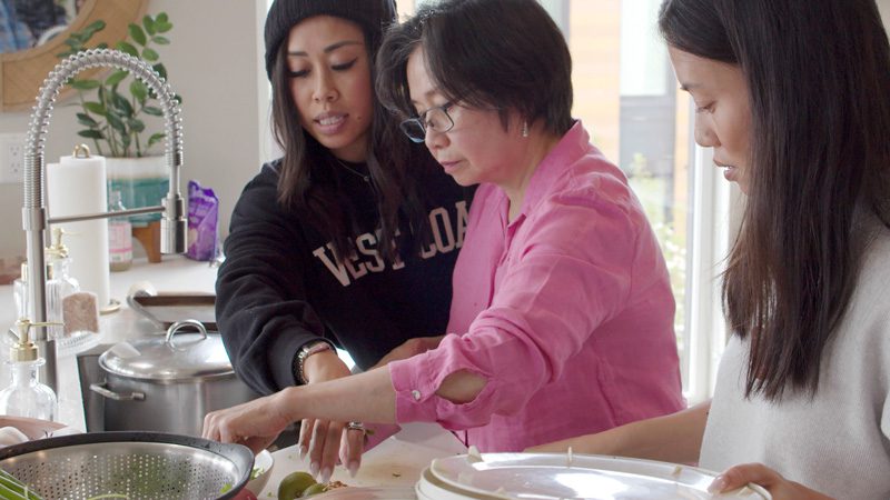 The Trinh family cooking chicken pho together.